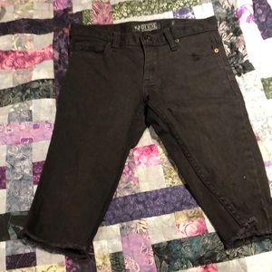 Men’s dark black cut off jeans.